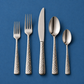 Chefcrest hammered-handle five-piece cutlery set on medium blue background