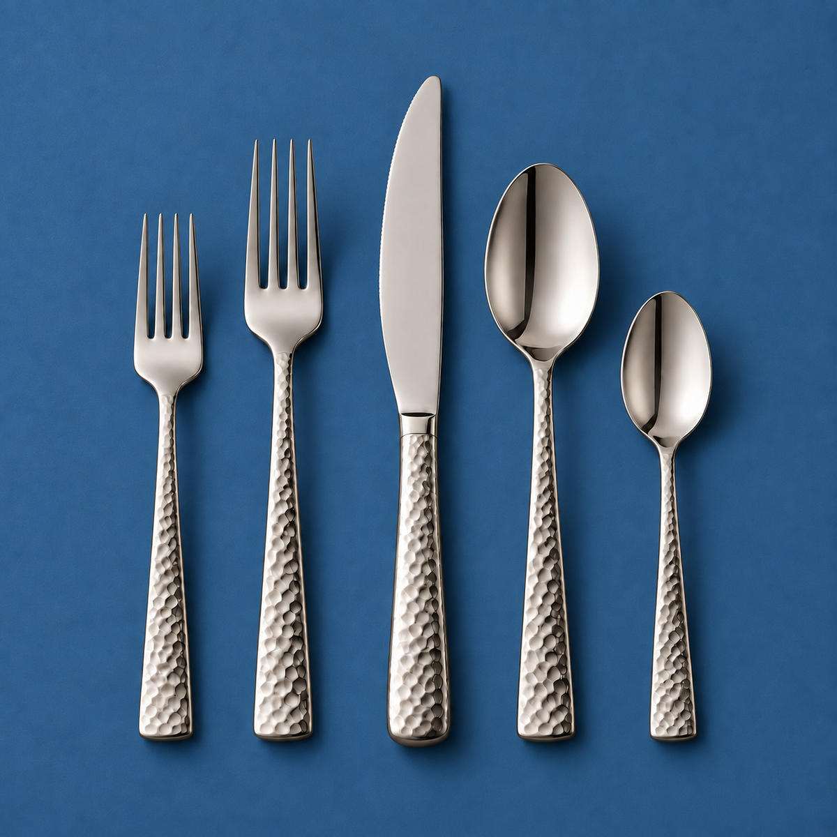 Chefcrest hammered-handle five-piece cutlery set on medium blue background